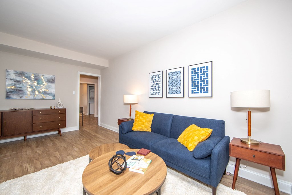 a living room with a blue couch and a coffee table