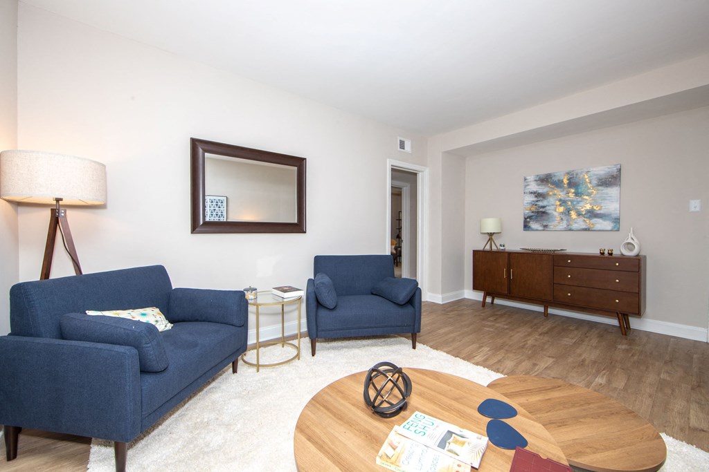 a living room with two blue couches and a coffee table