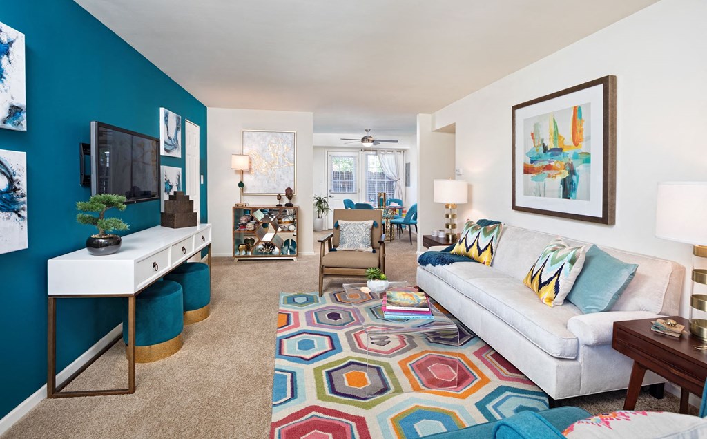 a living room with a blue wall and a white couch