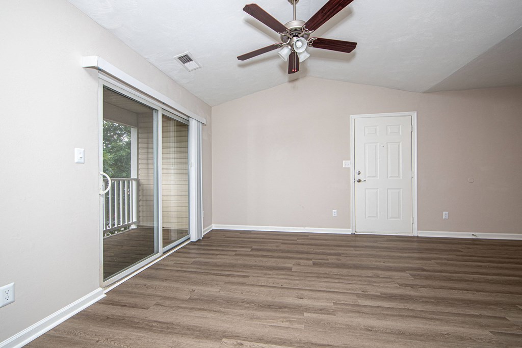 a bedroom with hardwood floors and a ceiling fan