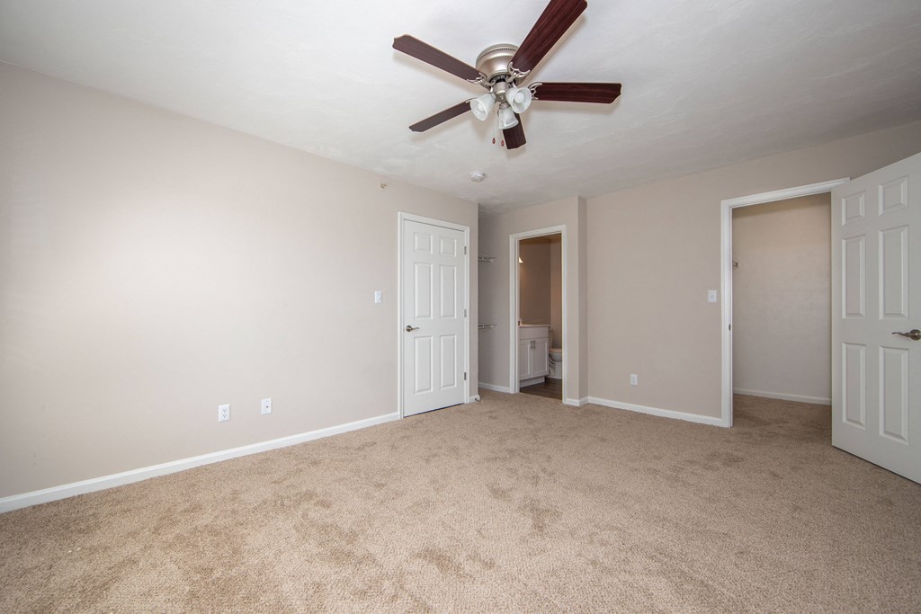 a bedroom with a ceiling fan