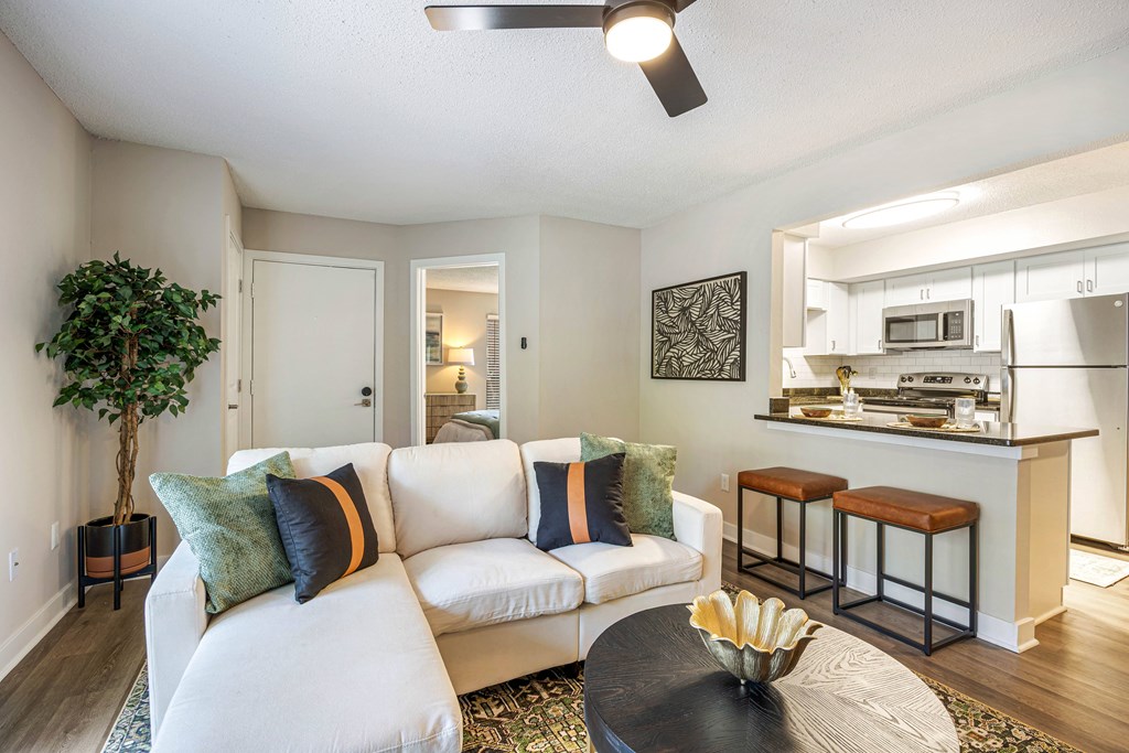 A living room with a white couch and a coffee table.