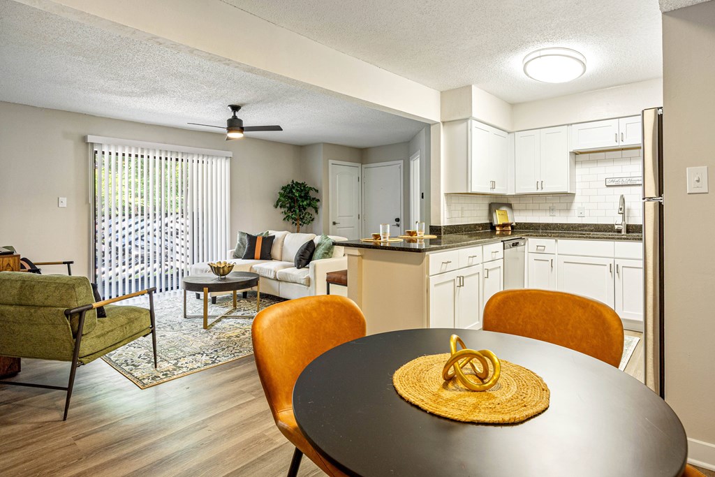 A dining room with a round table and chairs.