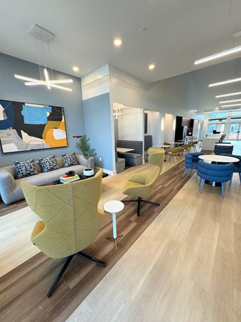 a living room with a couch and chairs and a table