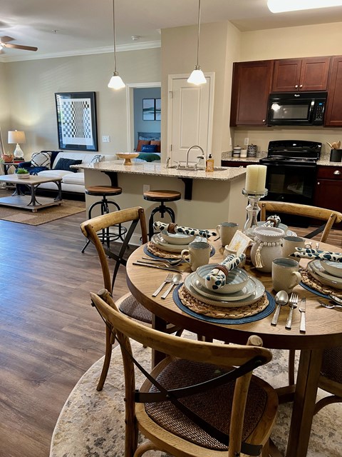 an open concept kitchen and living room with a dining table and chairs