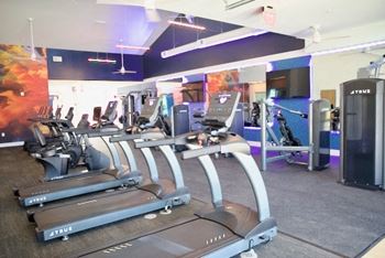 a gym with cardio machines and other exercise equipment