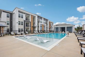 a swimming pool in front of an apartment building