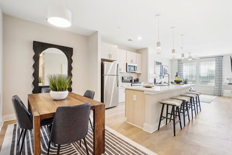 an open kitchen and dining area with a table and chairs