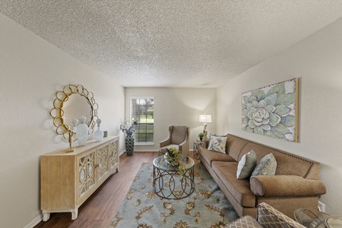 a living room with a couch and a table at Parks on the Green, Temple, Texas