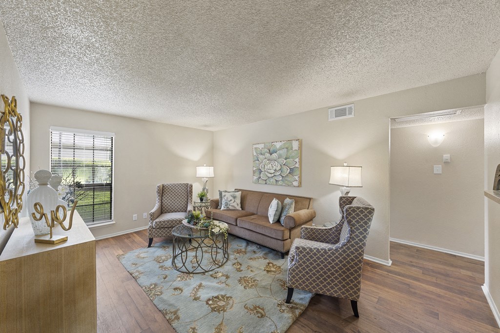 a living room with couches and chairs and a rug at Parks on the Green, Texas, 76504