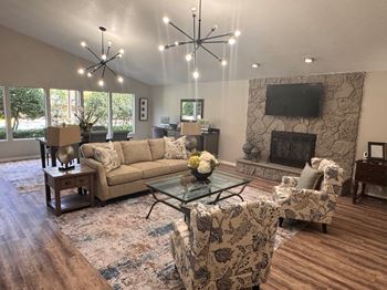 A living room with a fireplace and a television.
