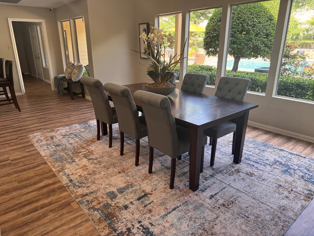 A dining room with a table and chairs.