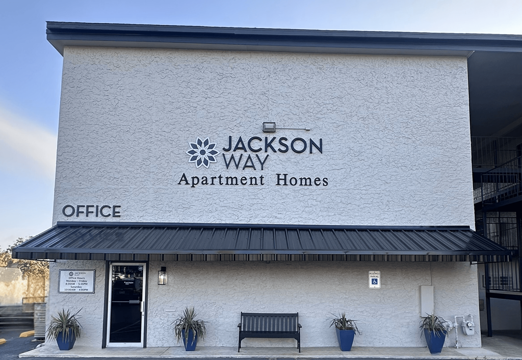 Jackson Way Apartment Homes office building with a black awning.