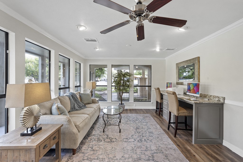 a living room with a couch and a ceiling fan  at Parks on the Green, Temple, Texas