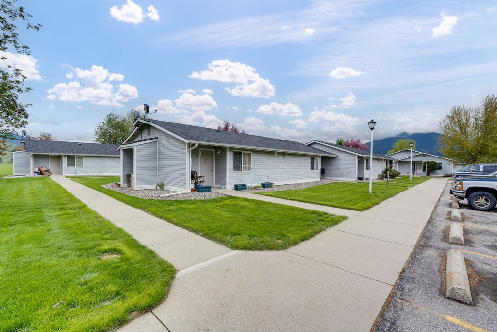 a white house with a sidewalk in front of it