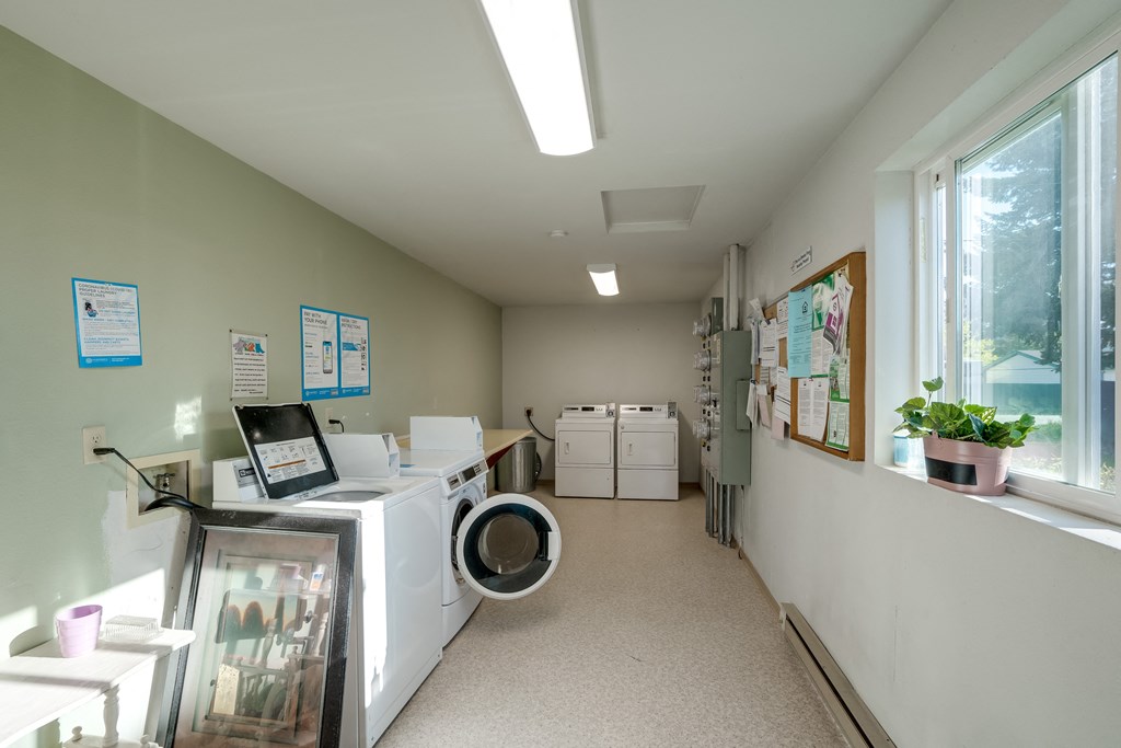 a laundry room with a washer and dryer and a window