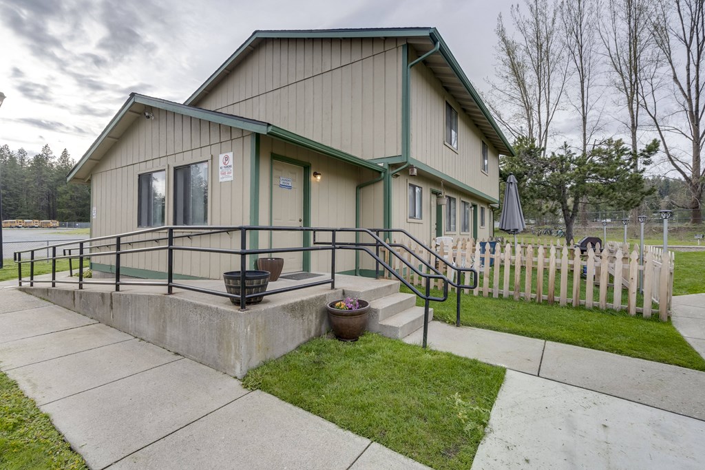 the front of a house with a ramp and a sidewalk