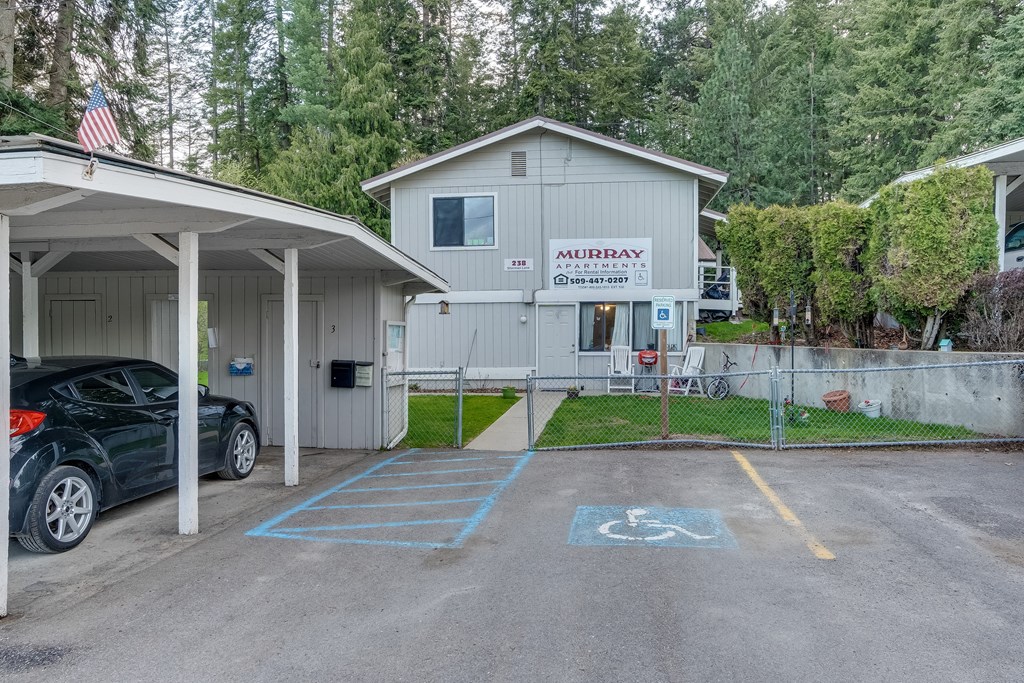 a parking lot with a car parked in front of a house