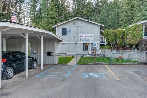 a parking lot with a car parked in front of a house