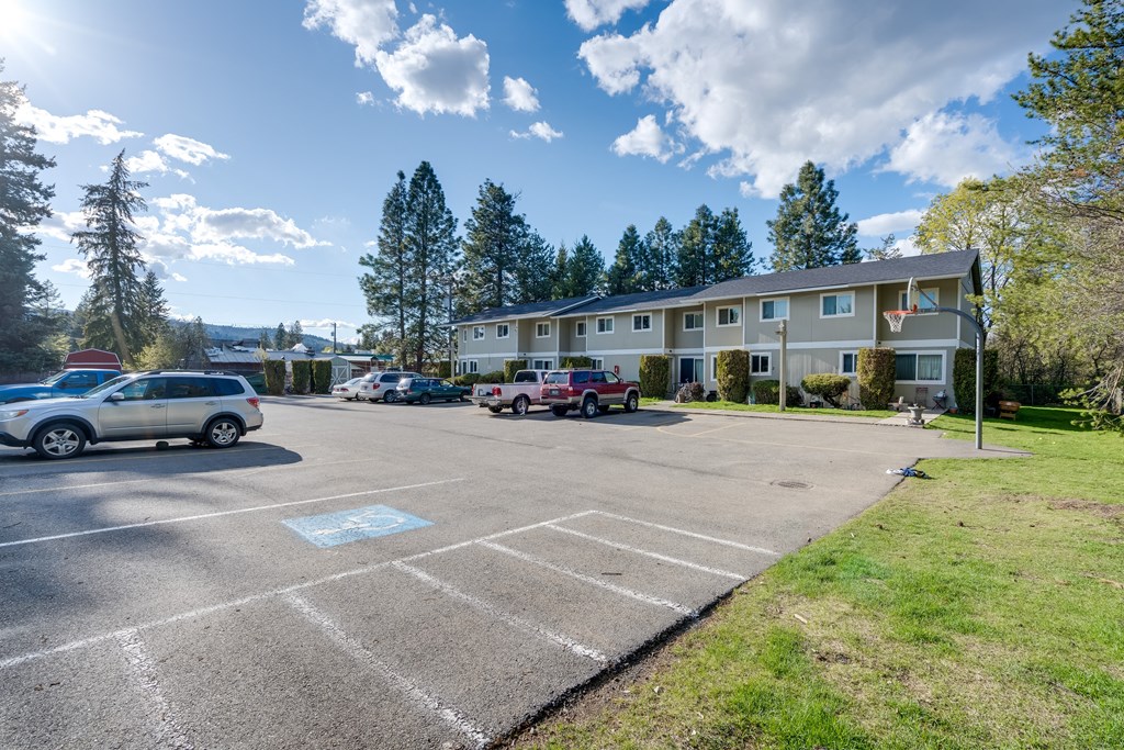 a parking lot with cars in front of a building