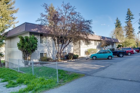 a white building with cars parked in front of it