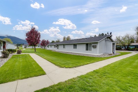 a white house with a lawn and a sidewalk