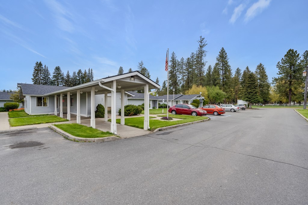 a white motel with cars parked in front of it