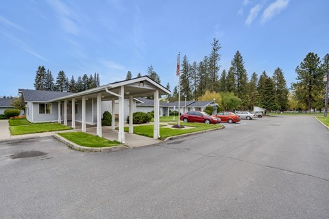 a white motel with cars parked in front of it