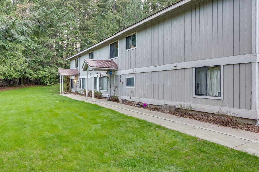 a white house with a yard and a sidewalk
