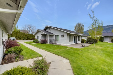 a white house with a yard and a sidewalk