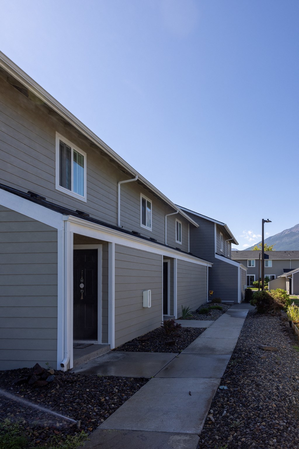A row of houses with a clear blue sky above them.