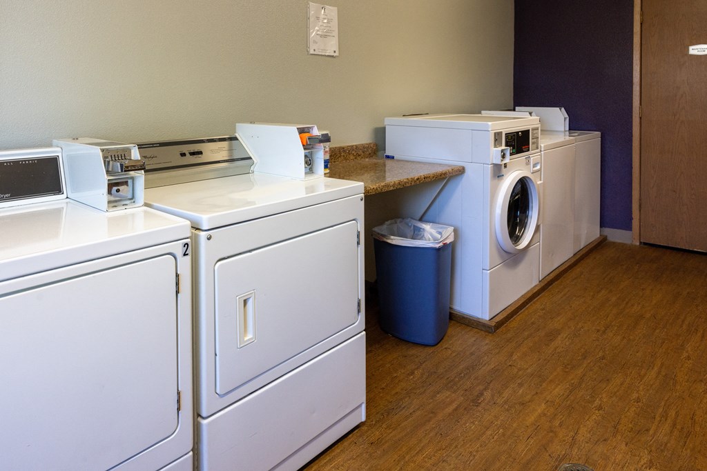 A row of washing machines in a laundromat.