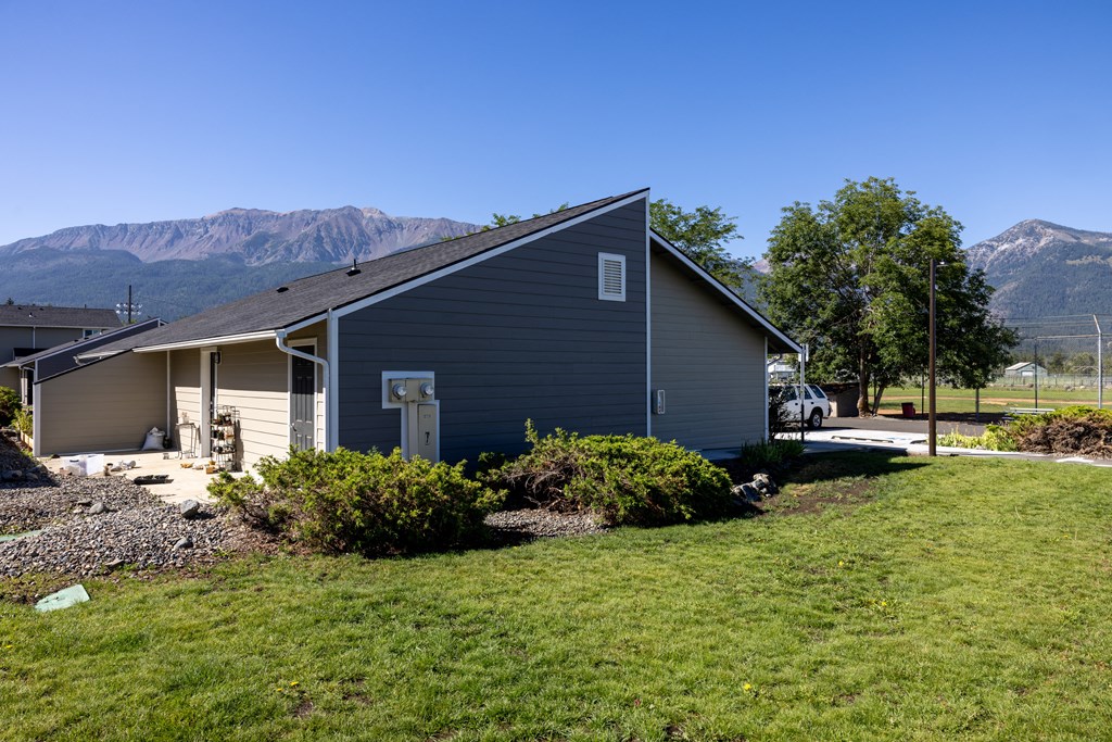 A house with a mountain in the background.