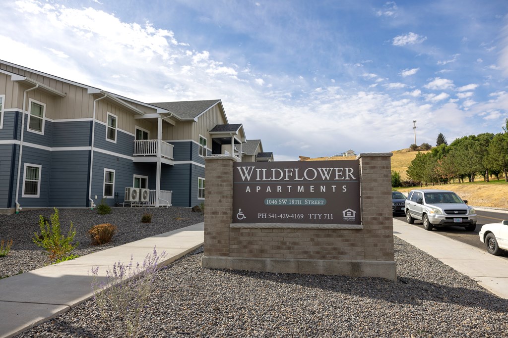 Wildflower Apartments sign in front of a building.
