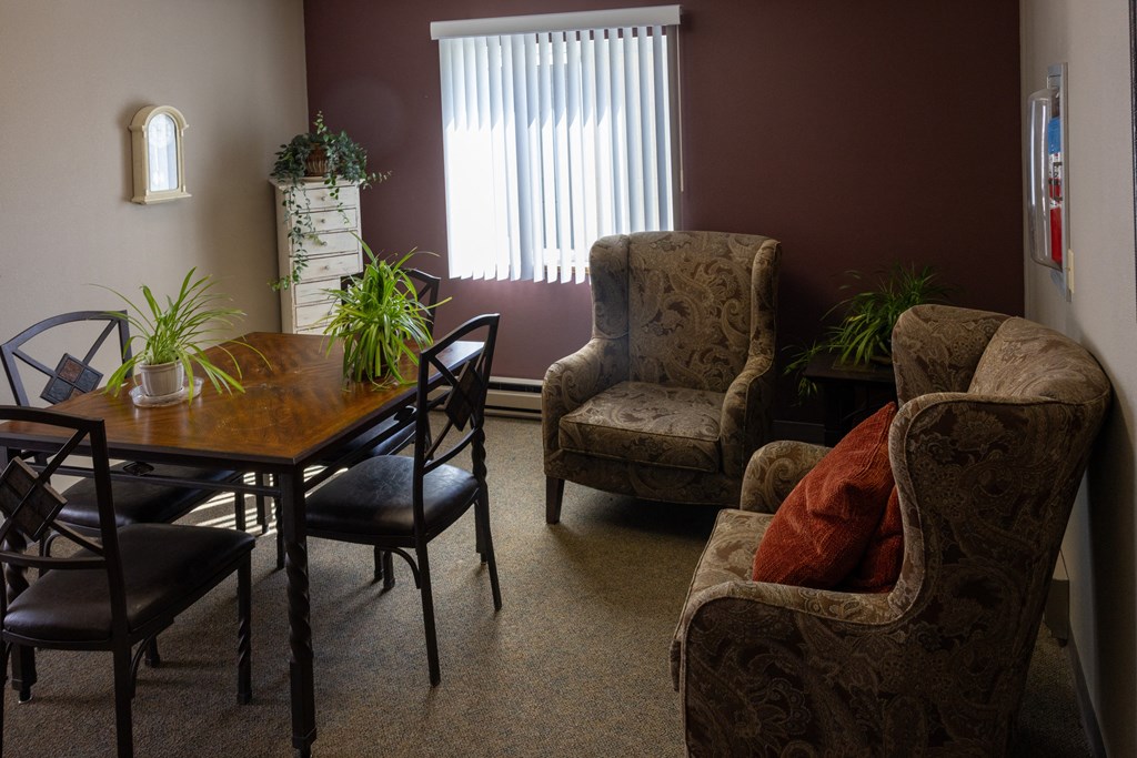 a living room with a dining room table and chairs