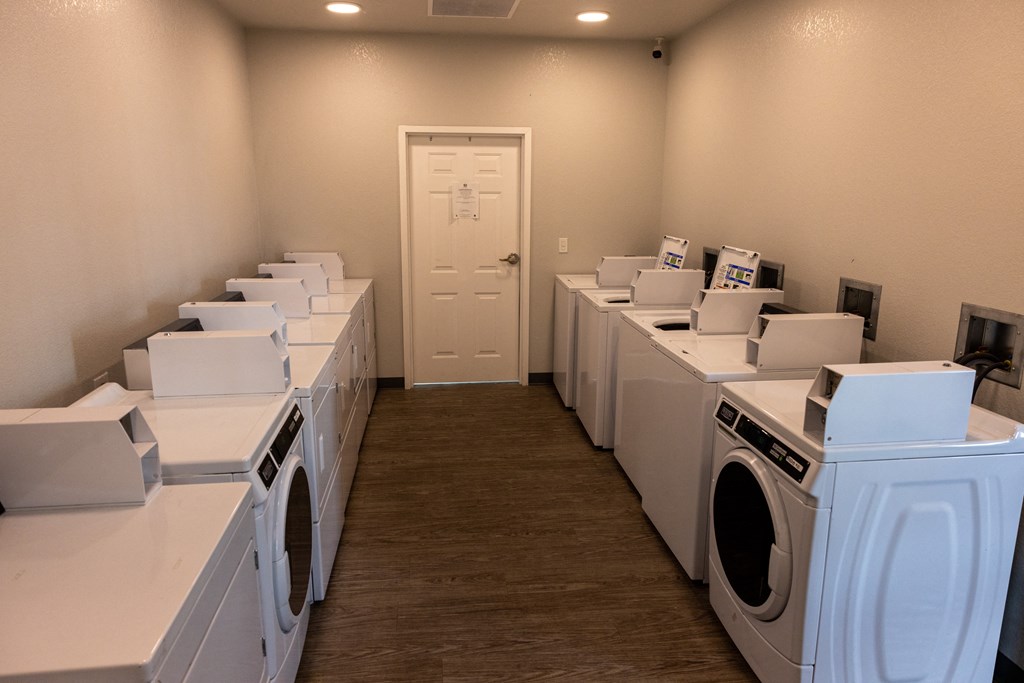 A row of washing machines in a laundromat.