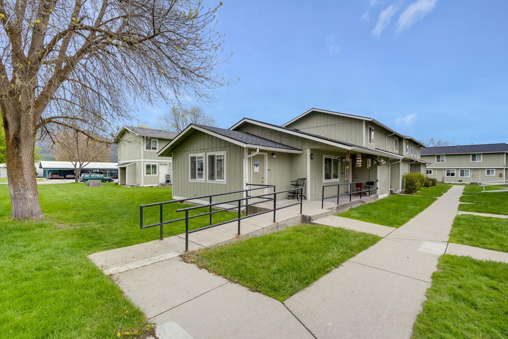 the view of a building with a sidewalk in front of it