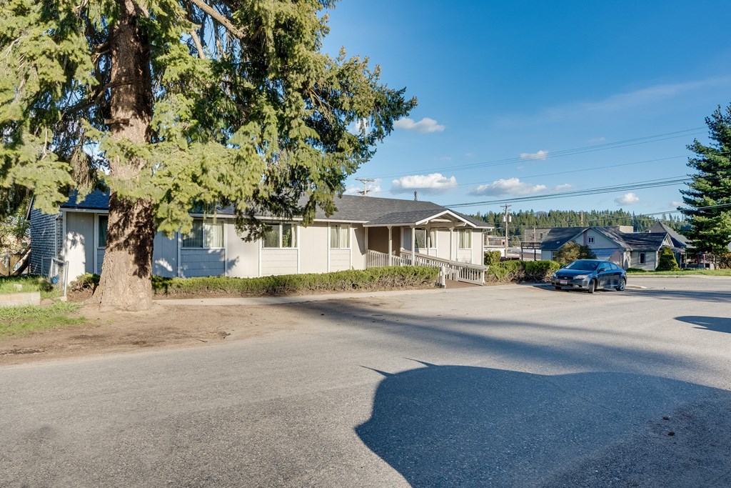 a street with houses and a car parked on the side of the road
