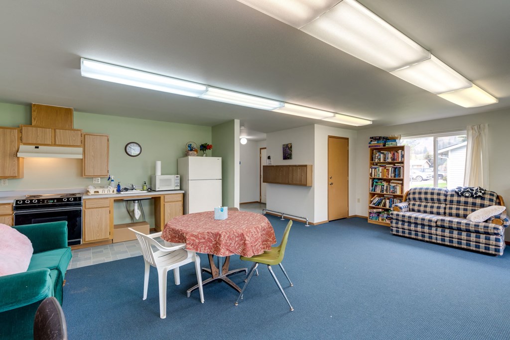 a living room with a kitchen and a dining table