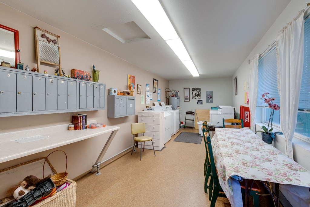 a patient room with a bed and a desk and cabinets