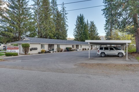 a parking lot with a car parked in front of a motel