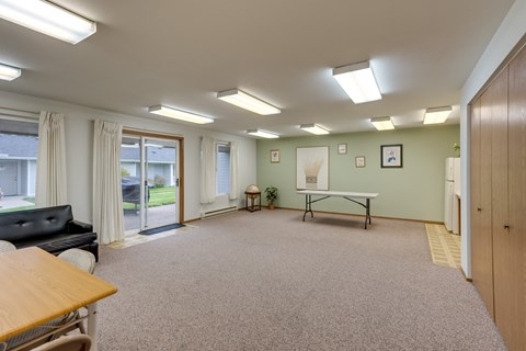 an empty room with a ping pong table in the center of it