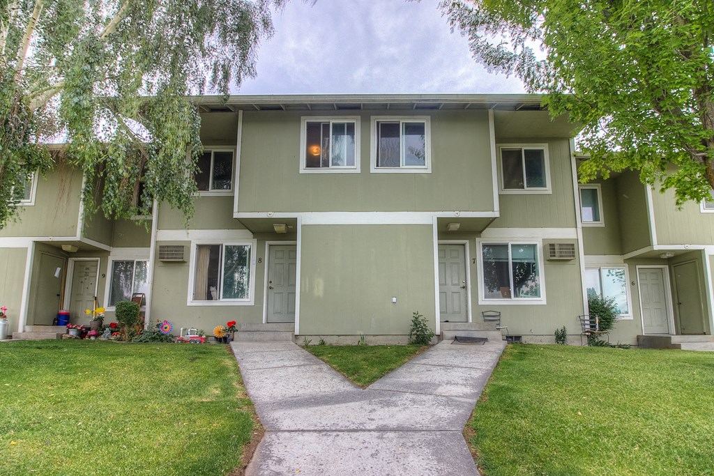 A building with a grey facade and a white door.
