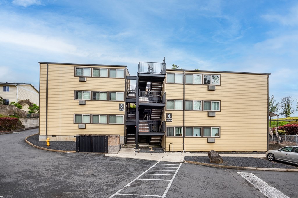 A beige building with a black staircase in front.