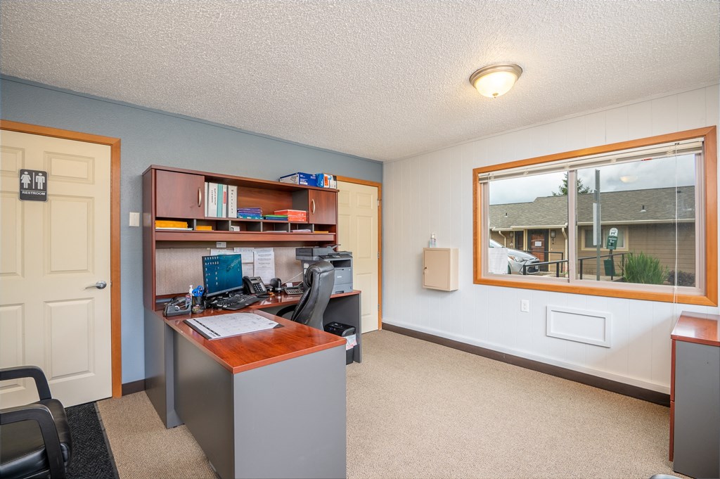 A room with a desk and a chair.