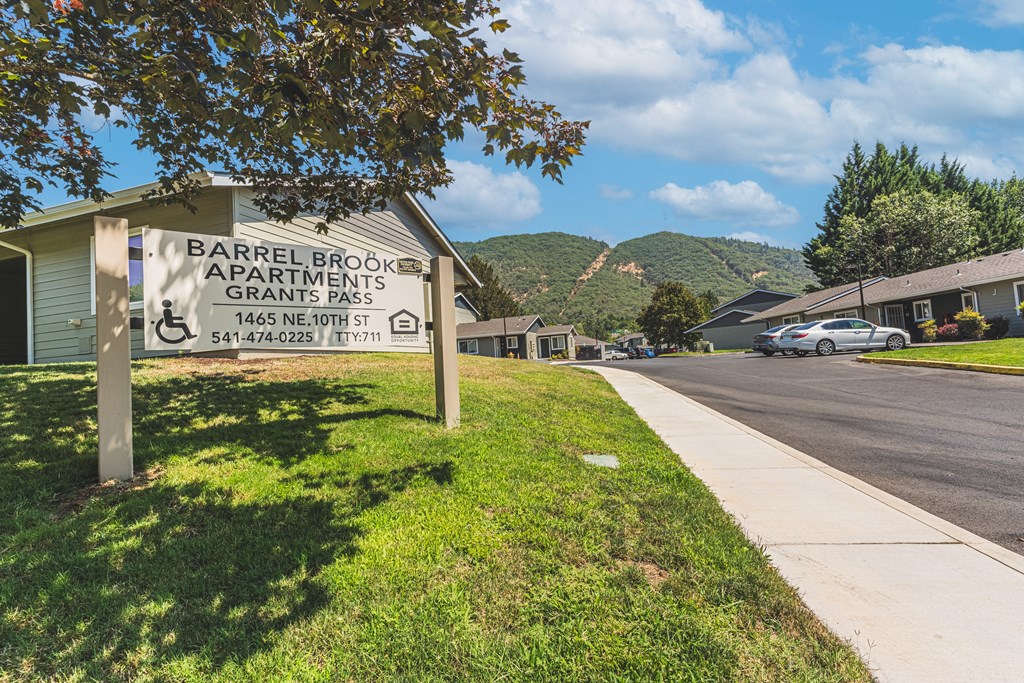 a sign apartments on the side of a street