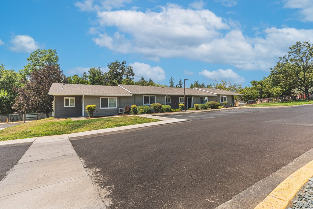 a house with a paved road in front of it