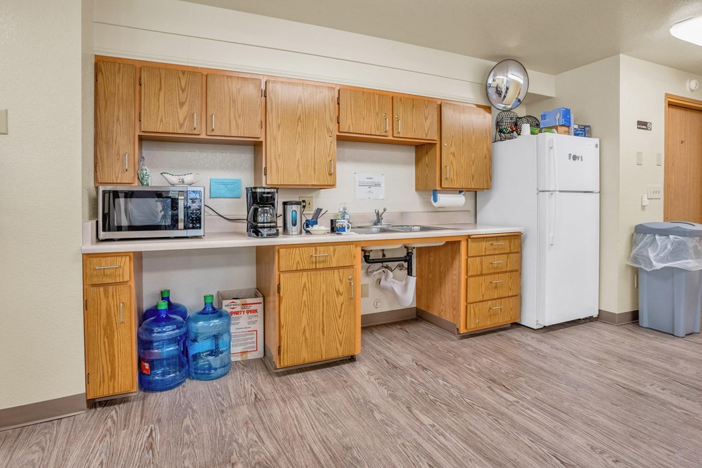 a kitchen with wooden cabinets and a sink and a refrigerator