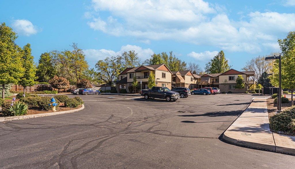 a city street with cars parked in front of houses
