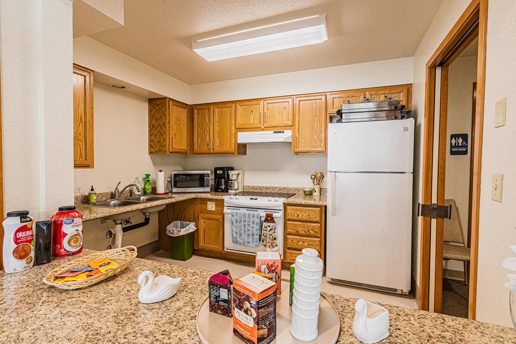 a kitchen with a counter with food and a refrigerator